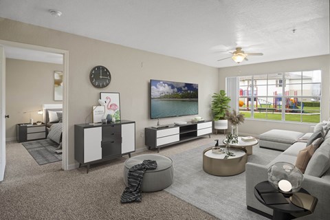 A living room with a grey couch, a coffee table, and a painting on the wall.