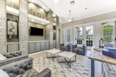 A living room with a grey couch and a wooden table.