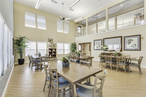 A dining room with a long table and chairs.