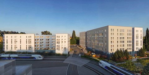 A modern building complex with a road in front of it.