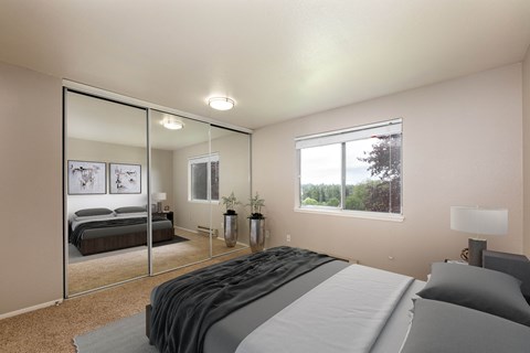 A bedroom with a large bed and a mirror on the wall.