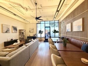 A modern living room with a long wooden table and chairs.