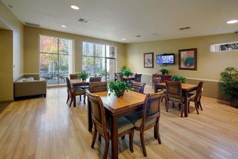 A dining room with a wooden table and chairs.