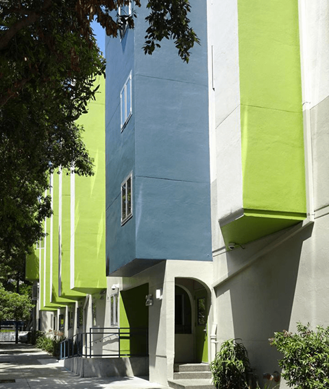 A building with a blue and green exterior is shown.