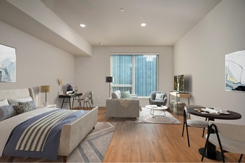 A well-lit bedroom with a large bed and a couch.