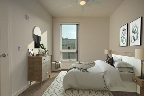 A bedroom with a large bed and a dresser with a mirror.