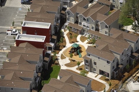 A bird's eye view of a neighborhood with houses and a central courtyard.