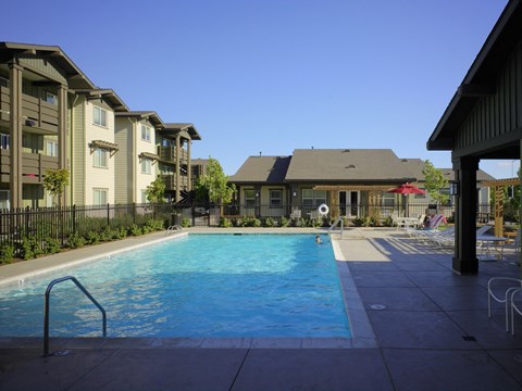 A swimming pool in front of apartment buildings.