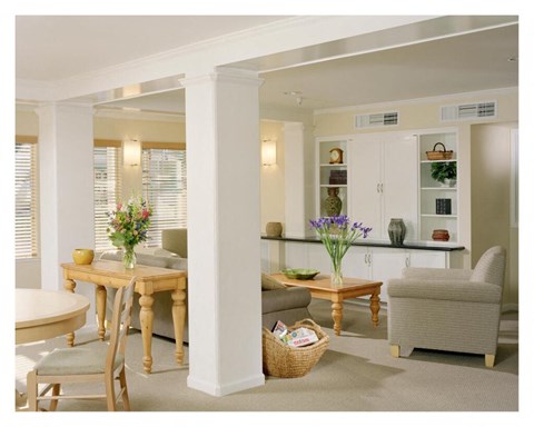 A dining room with a table and chairs.