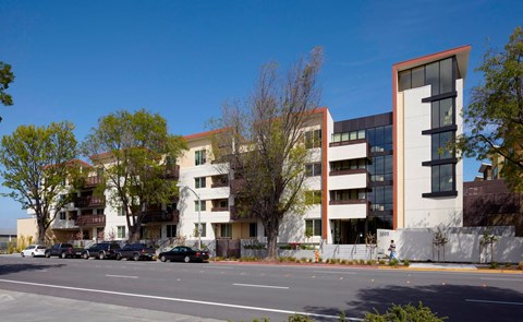 A modern building with a parking lot in front.