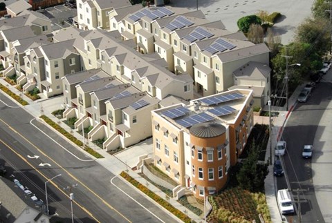 Apartment buildings with solar panels on the roofs.