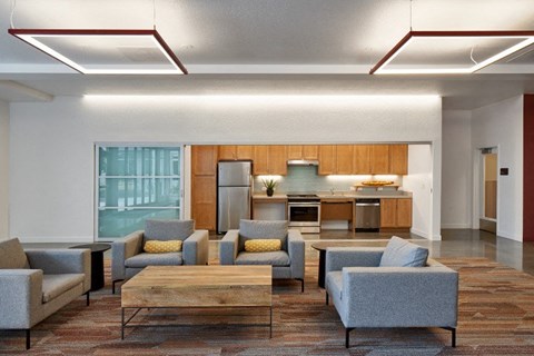 A modern living room with grey couches and a wooden coffee table.