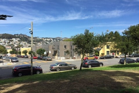 A street view with cars and buildings.