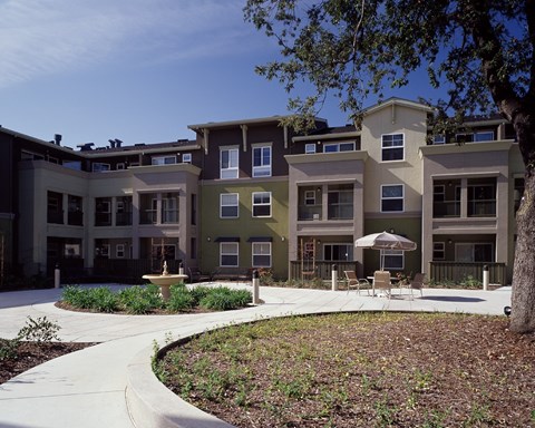 Apartment complex with a courtyard and a fountain.