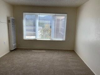 Empty room with a window and a door.