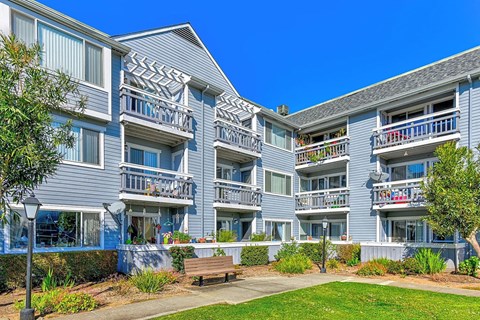 Apartment complex with a blue sky in the background.