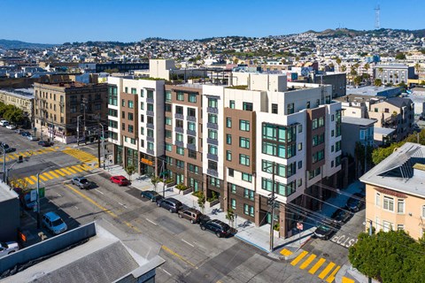A view of a city street with cars and buildings.