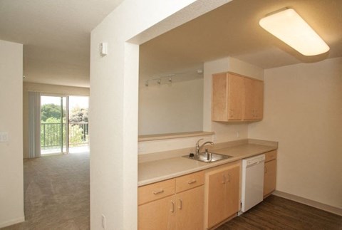A kitchen with wooden cabinets and a white countertop.