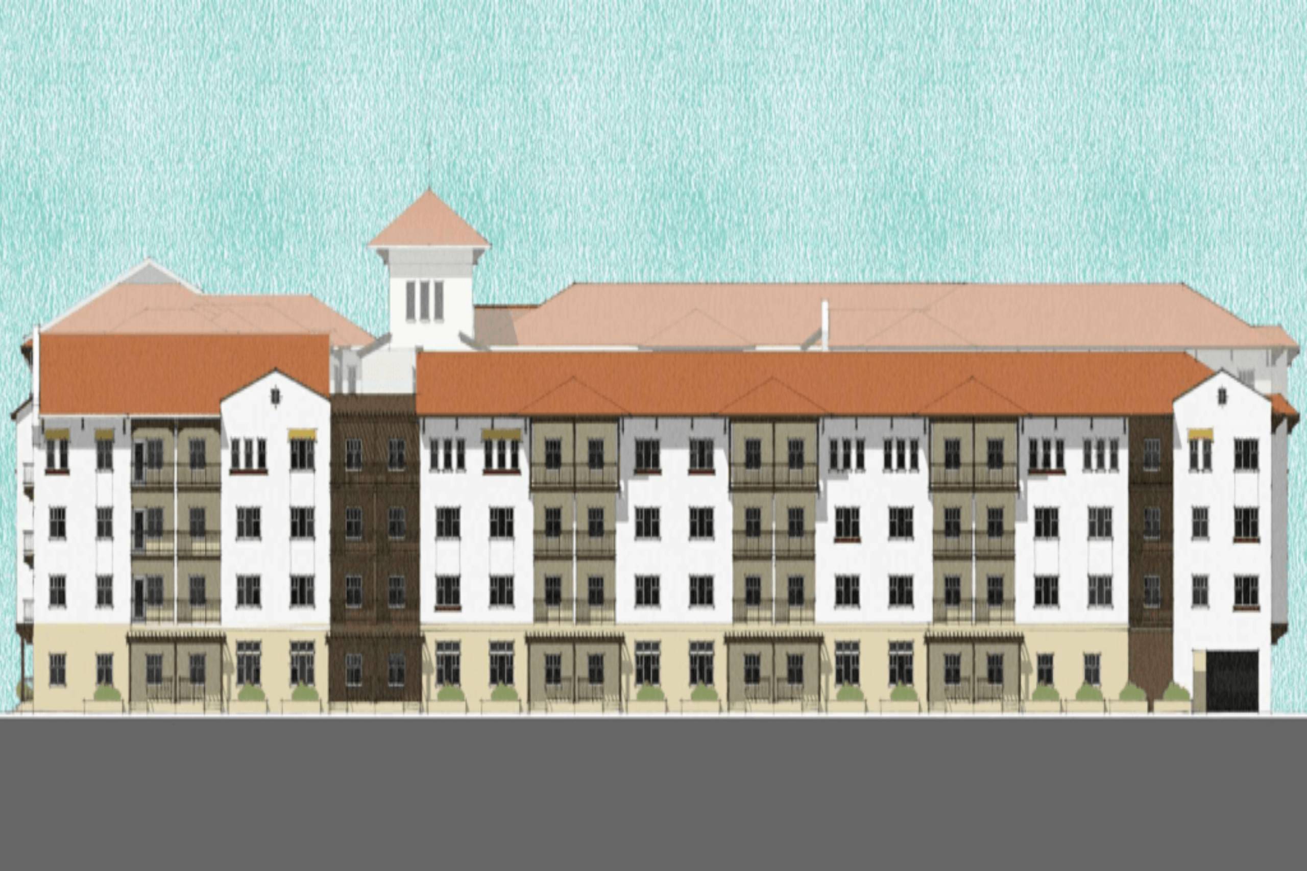 A building with a brown roof and white walls with a tower on top.