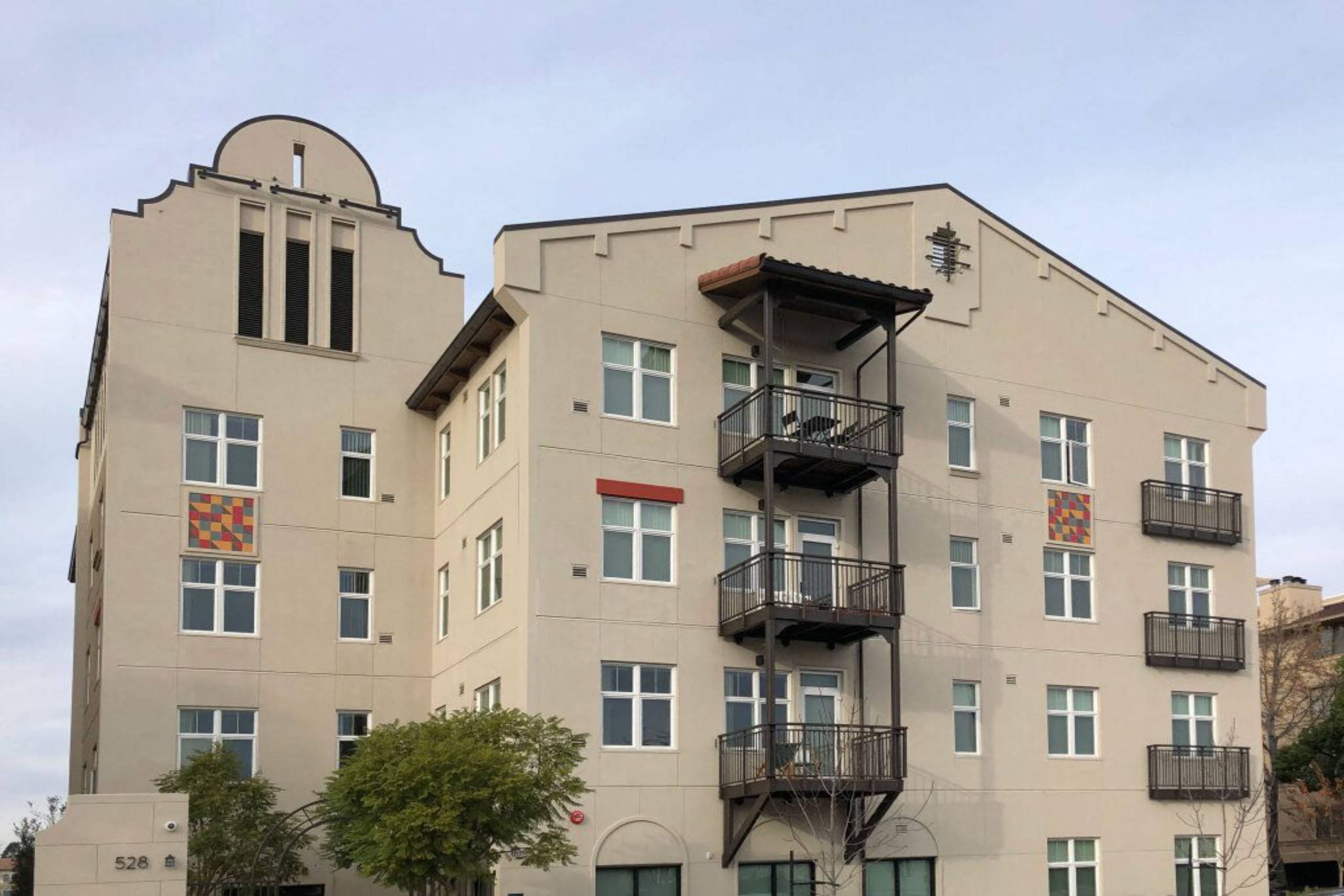 A large building with a balcony on the second floor.