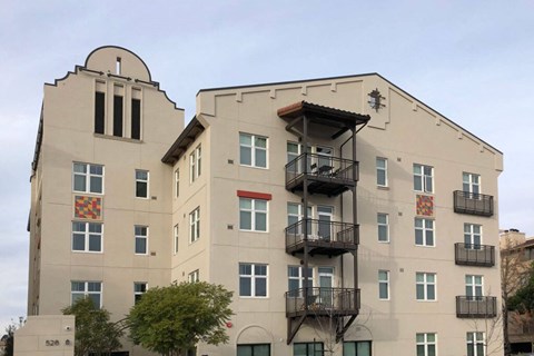 A large building with a balcony on the second floor.