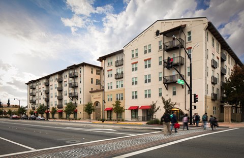 A street view of a city with buildings, cars, and pedestrians.