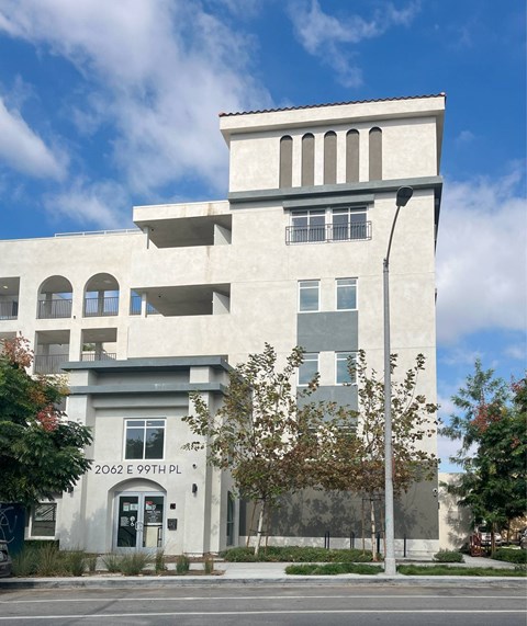A white building with a black door and windows.