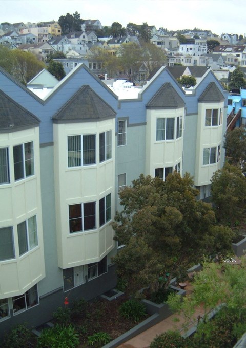 Apartment buildings with trees in front.