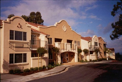 A row of houses with a clear blue sky above them.