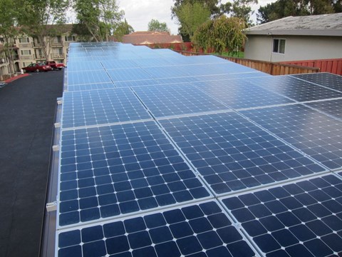 A large array of solar panels are installed on a roof.