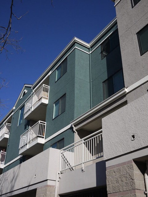 A building with balconies and a clear blue sky.