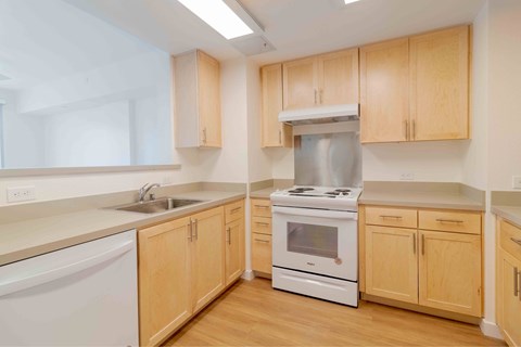 A kitchen with wooden cabinets and white appliances.
