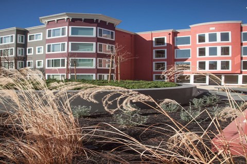 A modern building with a red and grey facade.