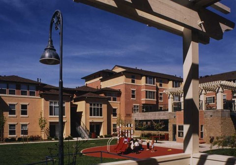 A playground area with a slide and a lamp post.