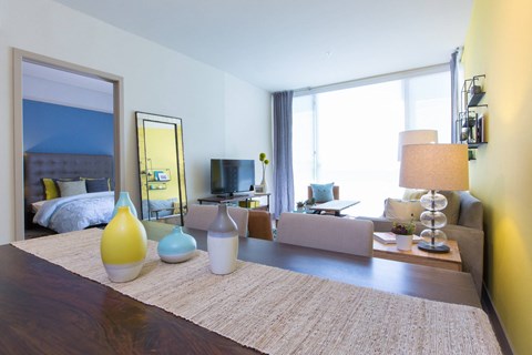 A well-lit bedroom with a large bed and a couch.