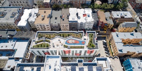 A bird's eye view of a city with a red and white building in the center.