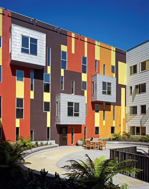 A modern building with a courtyard in front.
