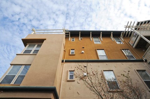 A building with a brown facade and multiple windows.