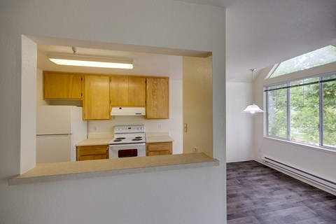 A kitchen with wooden cabinets and a stove top oven.