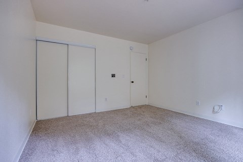 A room with carpeted floor and white walls.