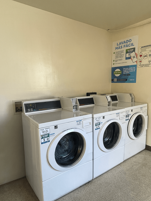 A row of washing machines in a laundromat.