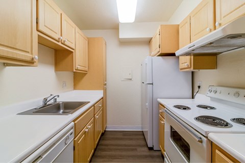 A kitchen with wooden cabinets and white appliances.
