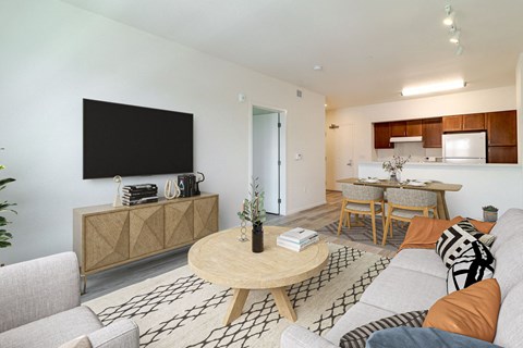 A living room with a wooden coffee table and a grey sofa.