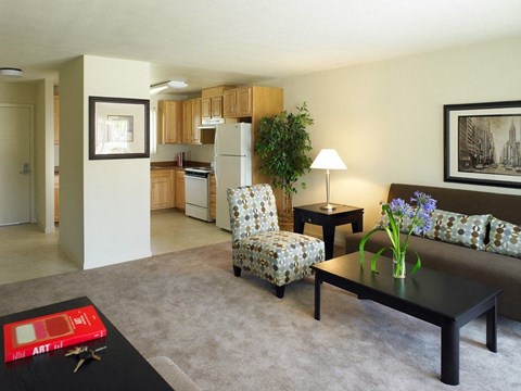 A living room with a couch, chair, and coffee table.