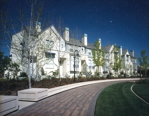 A large white building with a curved walkway in front of it.