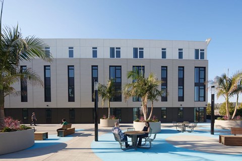 A modern building with a pool in front.