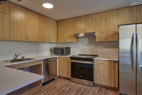 A kitchen with wooden cabinets and stainless steel appliances.