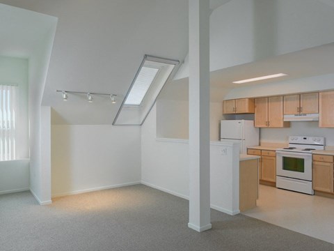 A kitchen with white appliances and wooden cabinets.