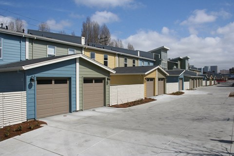 A row of houses with garages in front.