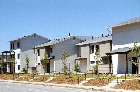 A row of modern houses with white and grey exteriors.